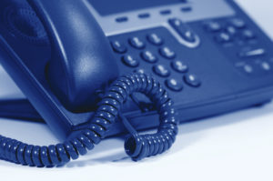 Modern Digital Phone. Shallow depth of field. Focus on cord. Visible texture of plastic.